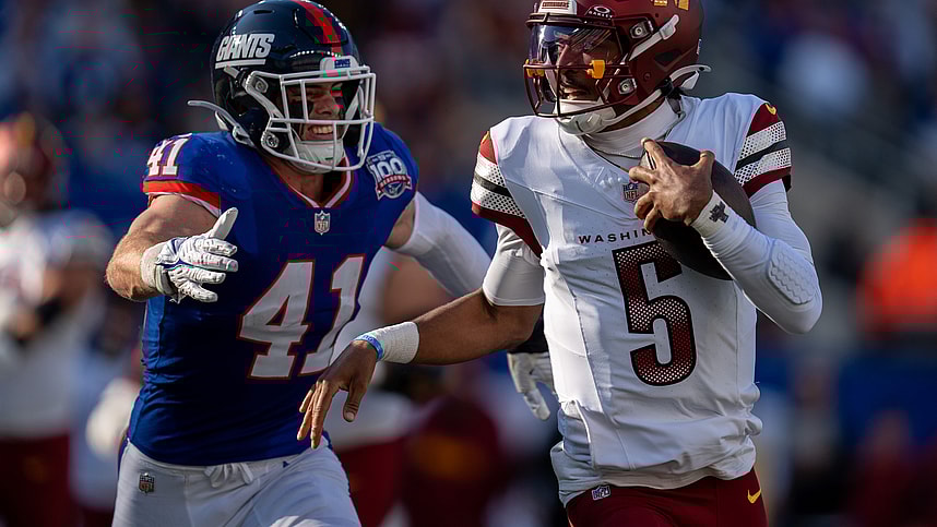 Washington Commanders quarterback Jayden Daniels (5) runs with the ball while being chased by New York Giants linebacker Micah McFadden (41) during a game between the New York Giants and the Washington Commanders at MetLife Stadium in East Rutherford on Sunday, Nov. 3, 2024.