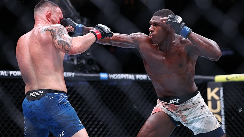 Dec 14, 2024; Tampa, Florida, UNITED STATES; Colby Covington (red gloves) fights Joaquin Buckley (blue gloves) at Amalie Arena. Mandatory Credit: Nathan Ray Seebeck-Imagn Images