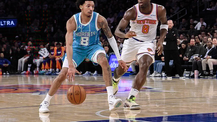 Dec 5, 2024; New York, New York, USA; Charlotte Hornets guard Nick Smith Jr. (8) drives to the basket while being defended by New York Knicks forward OG Anunoby (8) during the first half at Madison Square Garden. Mandatory Credit: John Jones-Imagn Images