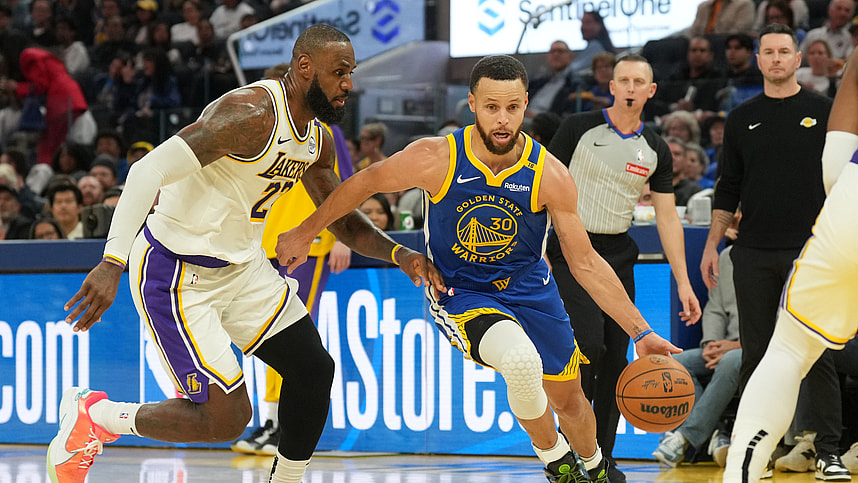 Dec 25, 2024; San Francisco, California, USA; Golden State Warriors guard Stephen Curry (30) dribbles against Los Angeles Lakers forward LeBron James (left) during the third quarter at Chase Center. Mandatory Credit: Darren Yamashita-Imagn Images