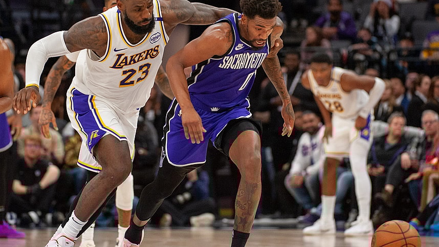 Dec 21, 2024; Sacramento, California, USA; Los Angeles Lakers forward LeBron James (23) and Sacramento Kings guard Malik Monk (0) fight for possession of the ball during the fourth quarter at Golden 1 Center. Mandatory Credit: Ed Szczepanski-Imagn Images