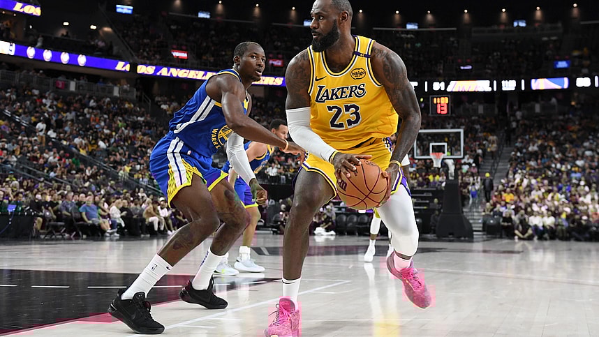 Oct 15, 2024; Las Vegas, Nevada, USA; Los Angeles Lakers forward LeBron James (23) dribbles past Golden State Warriors forward Jonathan Kuminga (00) in the third quarter during a preseason game at T-Mobile Arena. Mandatory Credit: Candice Ward-Imagn Images