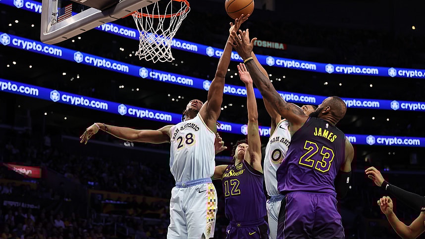 Jan 13, 2025; Los Angeles, California, USA; San Antonio Spurs center Charles Bassey (28) rebounds a ball against Los Angeles Lakers guard Max Christie (12) and forward LeBron James (23) during the second half at Crypto.com Arena. Mandatory Credit: Kiyoshi Mio-Imagn Images