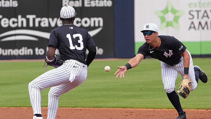 Mar 1, 2025; Tampa, Florida, USA; New York Yankees shortstop Anthony Volpe (11) tosses a ball to third base Jazz Chisholm Jr. (13) to make a double play during the third inning at George M. Steinbrenner Field. Mandatory Credit: Dave Nelson-Imagn Images