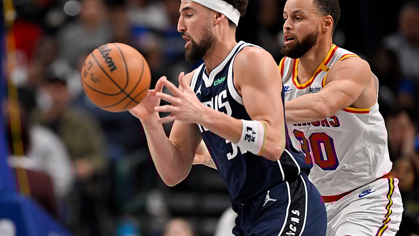 Feb 12, 2025; Dallas, Texas, USA; Dallas Mavericks guard Klay Thompson (31) moves the ball past Golden State Warriors guard Stephen Curry (30) during the second quarter at the American Airlines Center. Mandatory Credit: Jerome Miron-Imagn Images