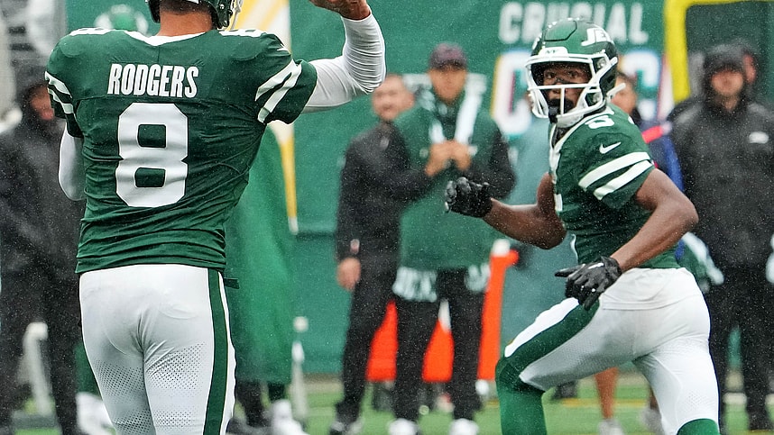 Sep 29, 2024; East Rutherford, New Jersey, USA;  New York Jets quarterback Aaron Rodgers (8) throws complete pass to wide receiver Garrett Wilson (5) against the Denver Broncos in the second half at MetLife Stadium. Mandatory Credit: Robert Deutsch-Imagn Images