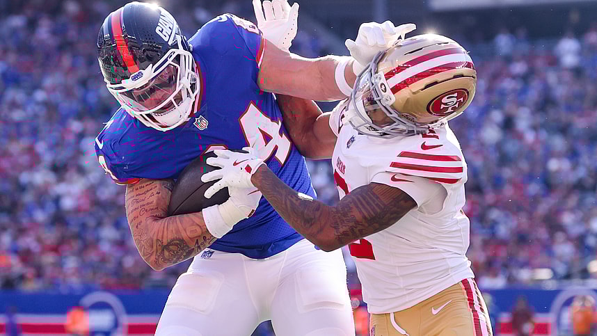 Nov 2, 2025; East Rutherford, New Jersey, USA; New York Giants tight end Theo Johnson (84) runs after the catch for a touchdown as San Francisco 49ers cornerback Deommodore Lenoir (2) defends during the first half at MetLife Stadium. Mandatory Credit: Ed Mulholland-Imagn Images