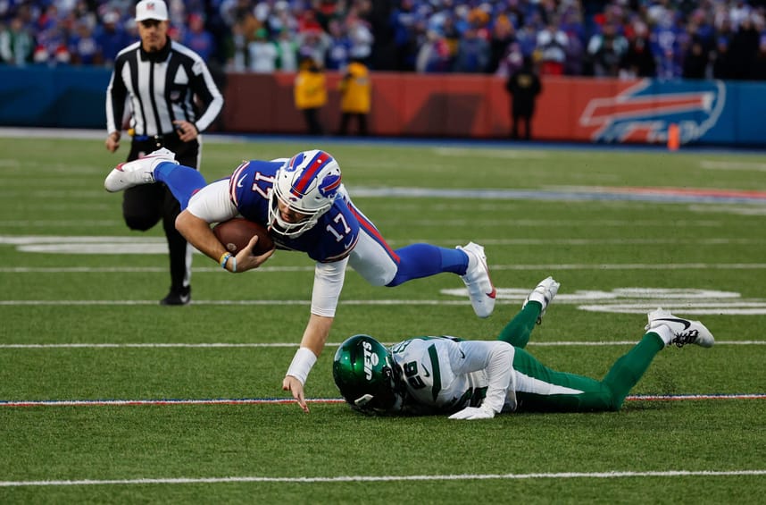 Buffalo Bills quarterback Josh Allen (17) is tackled by New York Jets running back Israel Abanikanda (25) after a short gain. Credit:Jamie Germano/Rochester Democrat and Chronicle / USA TODAY NETWORK