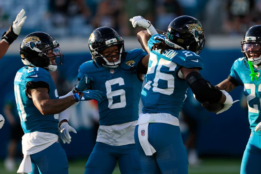 Greg Newsome II high-fives a Jaguars teammate after an interception