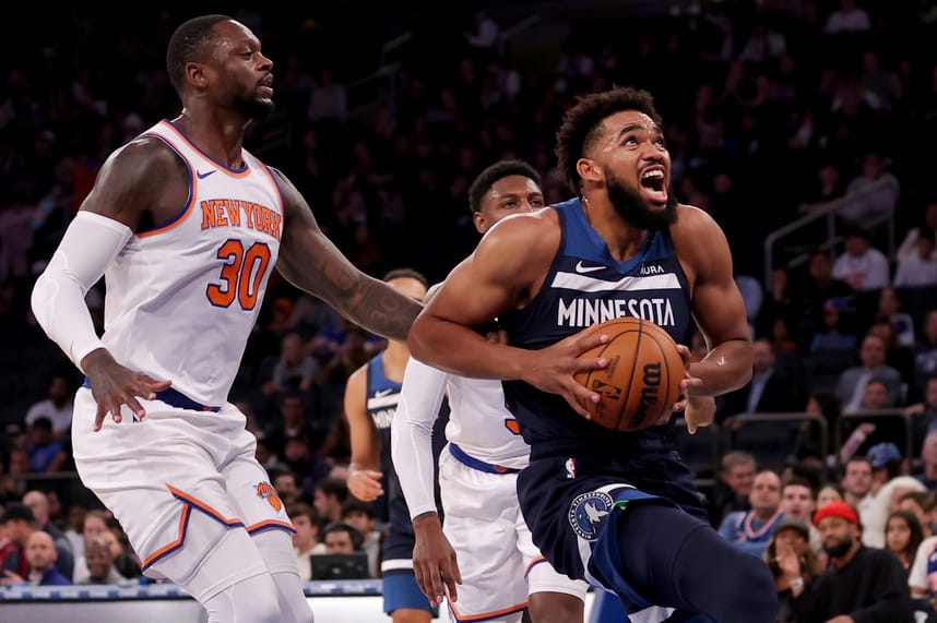 Minnesota Timberwolves center Karl-Anthony Towns (32) drives to the basket against New York Knicks forward Julius Randle (30) and guard RJ Barrett (9) during the first quarter at Madison Square Garden