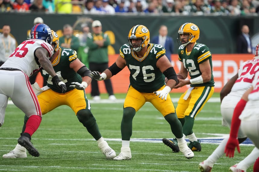 Green Bay Packers guard Jon Runyan (76) blocks as quarterback Aaron Rodgers (12) drops back to pass against the New York Giants during an NFL International Series game at Tottenham Hotspur Stadium