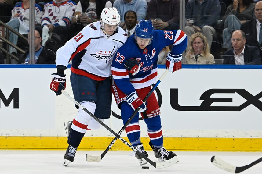 Apr 23, 2024; New York, New York, USA;  Washington Capitals center Aliaksei Protas (21) and New York Rangers defenseman Adam Fox (23) battle for the puck during the second period in game two of the first round of the 2024 Stanley Cup Playoffs at Madison Square Garden. Mandatory Credit: Dennis Schneidler-USA TODAY Sports