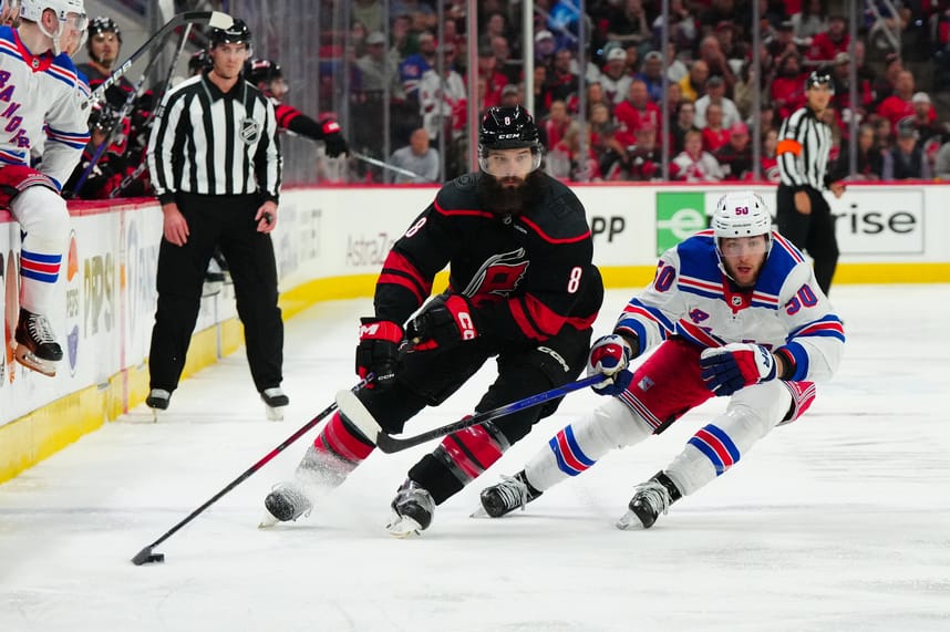 May 11, 2024; Raleigh, North Carolina, USA; Carolina Hurricanes defenseman Brent Burns (8) skates with the puck against New York Rangers left wing Will Cuylle (50) during the third period in game four of the second round of the 2024 Stanley Cup Playoffs at PNC Arena. Mandatory Credit: James Guillory-USA TODAY Sports