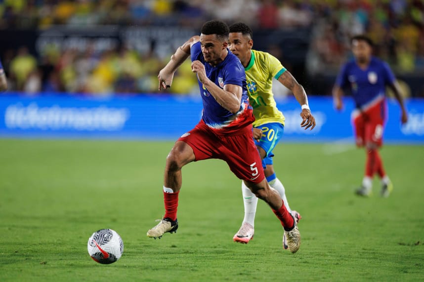 Jun 12, 2024; Orlando, Florida, USA; United States defender Antonee Robinson (5) and Brazil forward Savio (20) battle for the ball in the second half during the Continental Clasico at Camping World Stadium. Mandatory Credit: Nathan Ray Seebeck-USA TODAY Sports