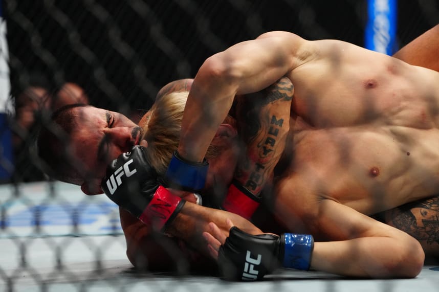 Dec 7, 2024; Las Vegas, Nevada, UNITED STATES; Alexandre Pantoja (red gloves) fights Kai Asakura (blues gloves) at T-Mobile Arena. Mandatory Credit: Stephen R. Sylvanie-Imagn Images