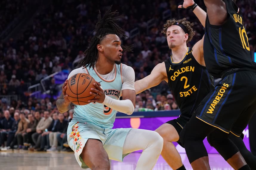 Apr 9, 2025; San Francisco, California, USA;  San Antonio Spurs guard Stephon Castle (5) dribbles against Golden State Warriors guard Brandin Podziemski (2) and forward Jimmy Butler III (10) in the fourth quarter at Chase Center. Mandatory Credit: David Gonzales-Imagn Images