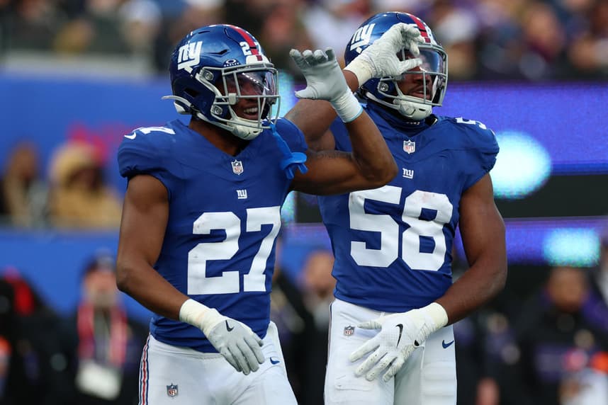 Tyler Nubin reacts with Bobby Okereke during a Giants game
