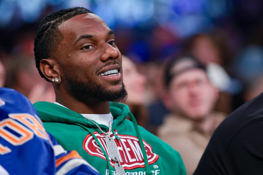 Malik Nabers sits courtside during a Knicks game in New York