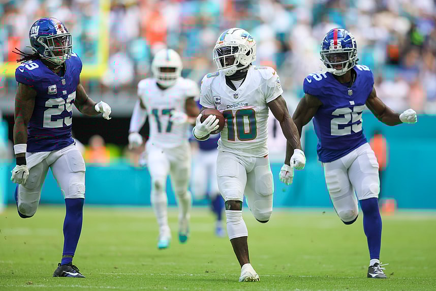 Oct 8, 2023; Miami Gardens, Florida, USA; Miami Dolphins wide receiver Tyreek Hill (10) runs with the football ahead of New York Giants cornerback Deonte Banks (25) and safety Xavier McKinney (29) during the second quarter at Hard Rock Stadium. Mandatory Credit: Sam Navarro-Imagn Images