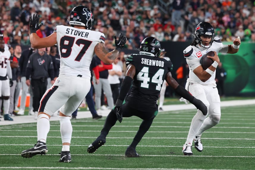 Oct 31, 2024; East Rutherford, New Jersey, USA; Houston Texans quarterback C.J. Stroud (7) runs with the ball while New York Jets linebacker Jamien Sherwood (44) attempts to tackle him during the first half at MetLife Stadium. Mandatory Credit: Ed Mulholland-Imagn Images