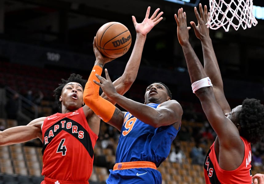 New York Knicks guard RJ Barrett (9) tries to shoot the ball as Toronto Raptors forwards Scottie Barnes (4) and OG Anunoby (3) defend in the first half at Scotiabank Arena