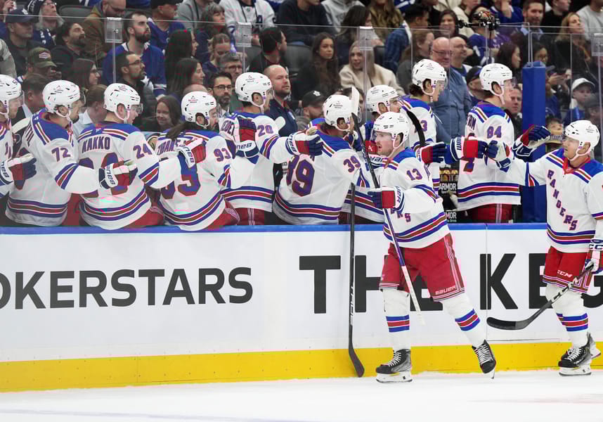 Oct 19, 2024; Toronto, Ontario, CAN; New York Rangers left wing Alexis Lafreniere (13) celebrates at the bench after scoring a goal against the Toronto Maple Leafs during the first period at Scotiabank Arena. Mandatory Credit: Nick Turchiaro-Imagn Images