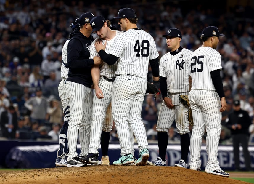Oct 30, 2024; New York, New York, USA; New York Yankees first baseman Anthony Rizzo (48) talks to New York Yankees pitcher Gerrit Cole (45) after he was removed from the game during the seventh inning against the Los Angeles Dodgers in game five of the 2024 MLB World Series at Yankee Stadium. Mandatory Credit: Vincent Carchietta-Imagn Images