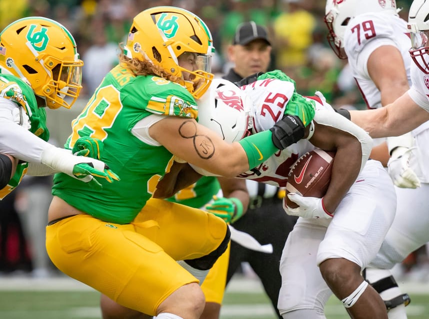 Oregon defensive lineman Casey Rogers stops Washington State running back Nakia Watson as the No. 9 Oregon Ducks host Washington State Saturday, Oct. 21, 2023, at Autzen Stadium in Eugene, Ore.