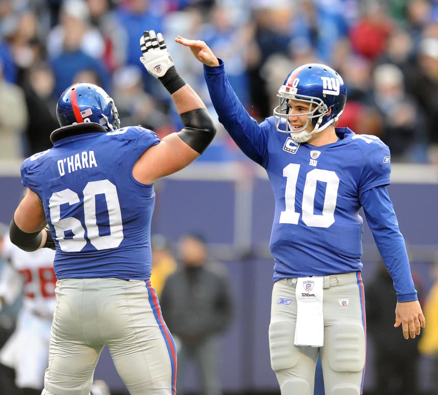 Eli Manning, giants, Bergen, East Rutherford 11/22/2009 GIANTS STADIUM Giants Eli Manning gets a high five from Shaun O'Hara after a second half