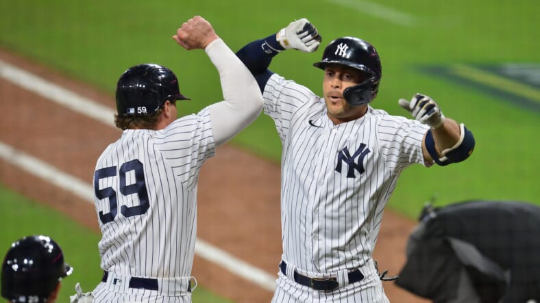 New York Yankees' Giancarlo Stanton (27) celebrates with Aaron