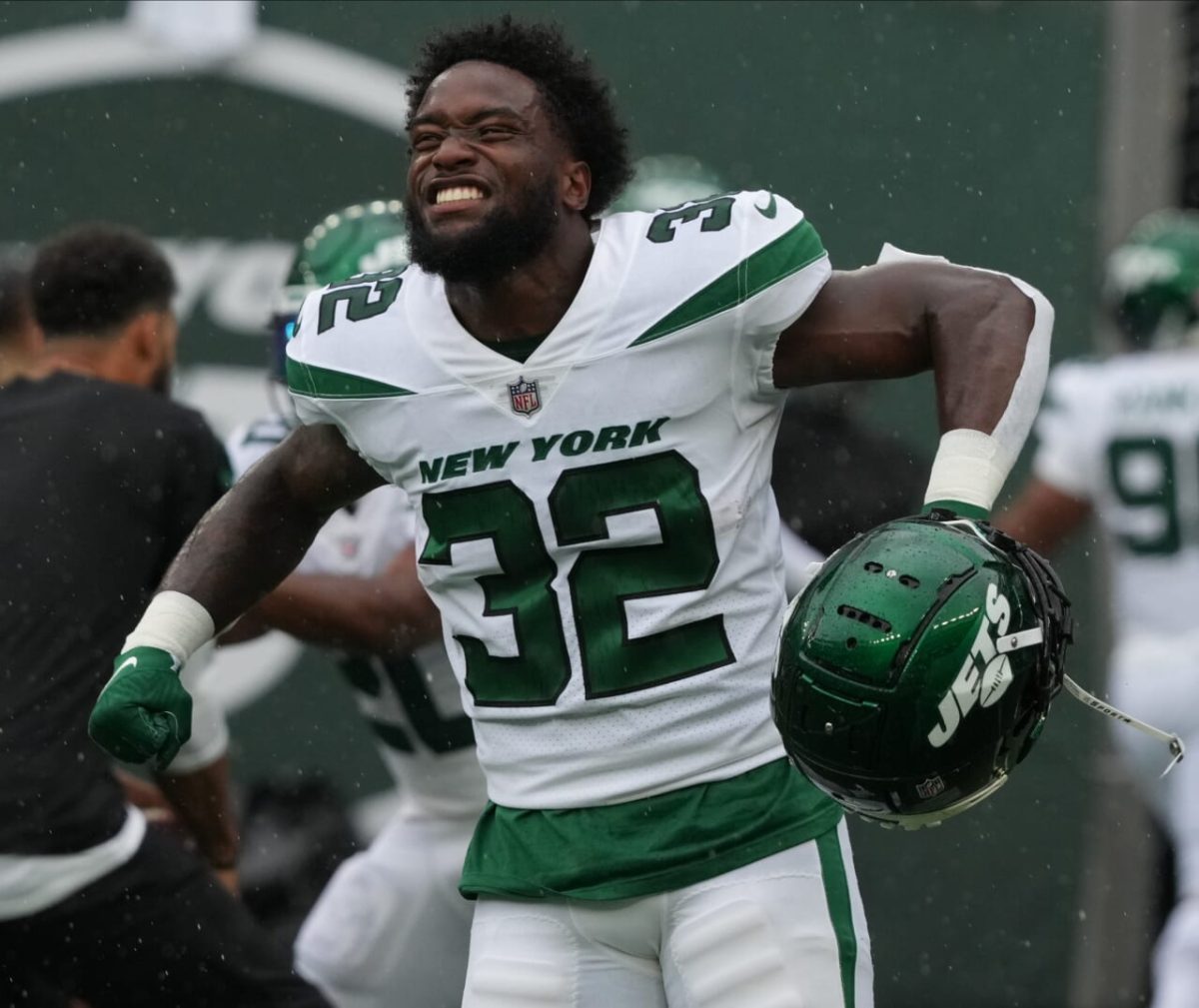 New York Jets running back Michael Carter (32) warms up before taking on  the Miami Dolphins during an NFL football game Sunday, Oct. 9, 2022, in  East Rutherford, N.J. (AP Photo/Adam Hunger