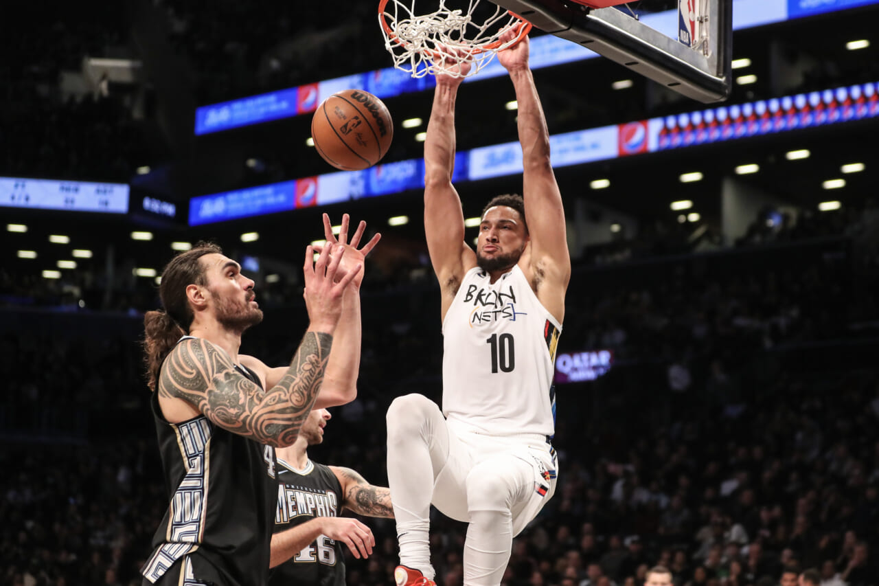 Brooklyn Nets' Ben Simmons, left, dunks as Philadelphia 76ers