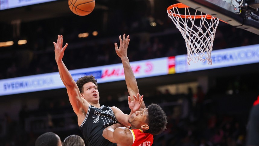 San Antonio Spurs forward Isaiah Roby (18, New York Knicks) shoots over Atlanta Hawks forward De'Andre Hunter (12) in the second quarter at State Farm Arena