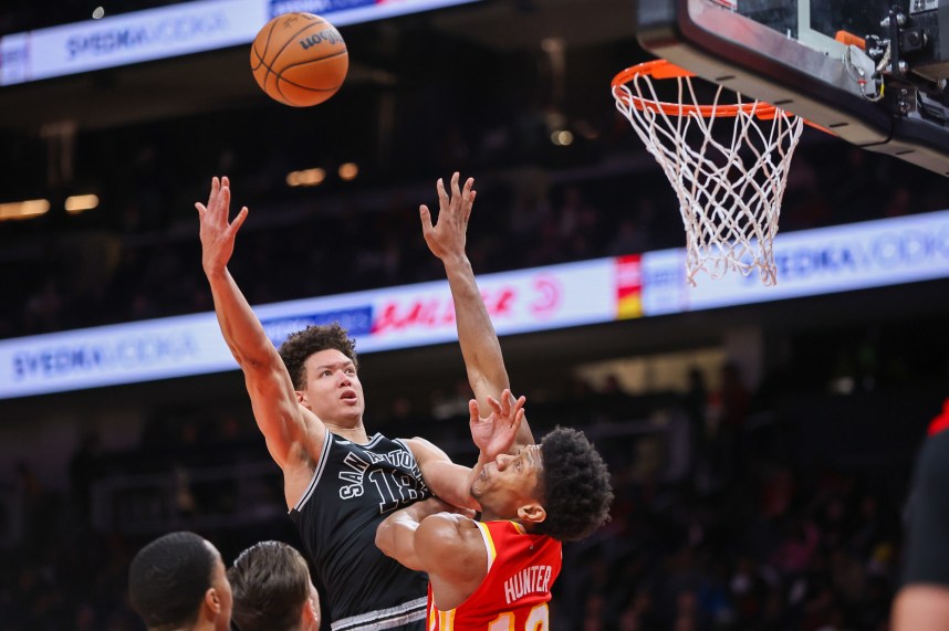 San Antonio Spurs forward Isaiah Roby (18, New York Knicks) shoots over Atlanta Hawks forward De'Andre Hunter (12) in the second quarter at State Farm Arena