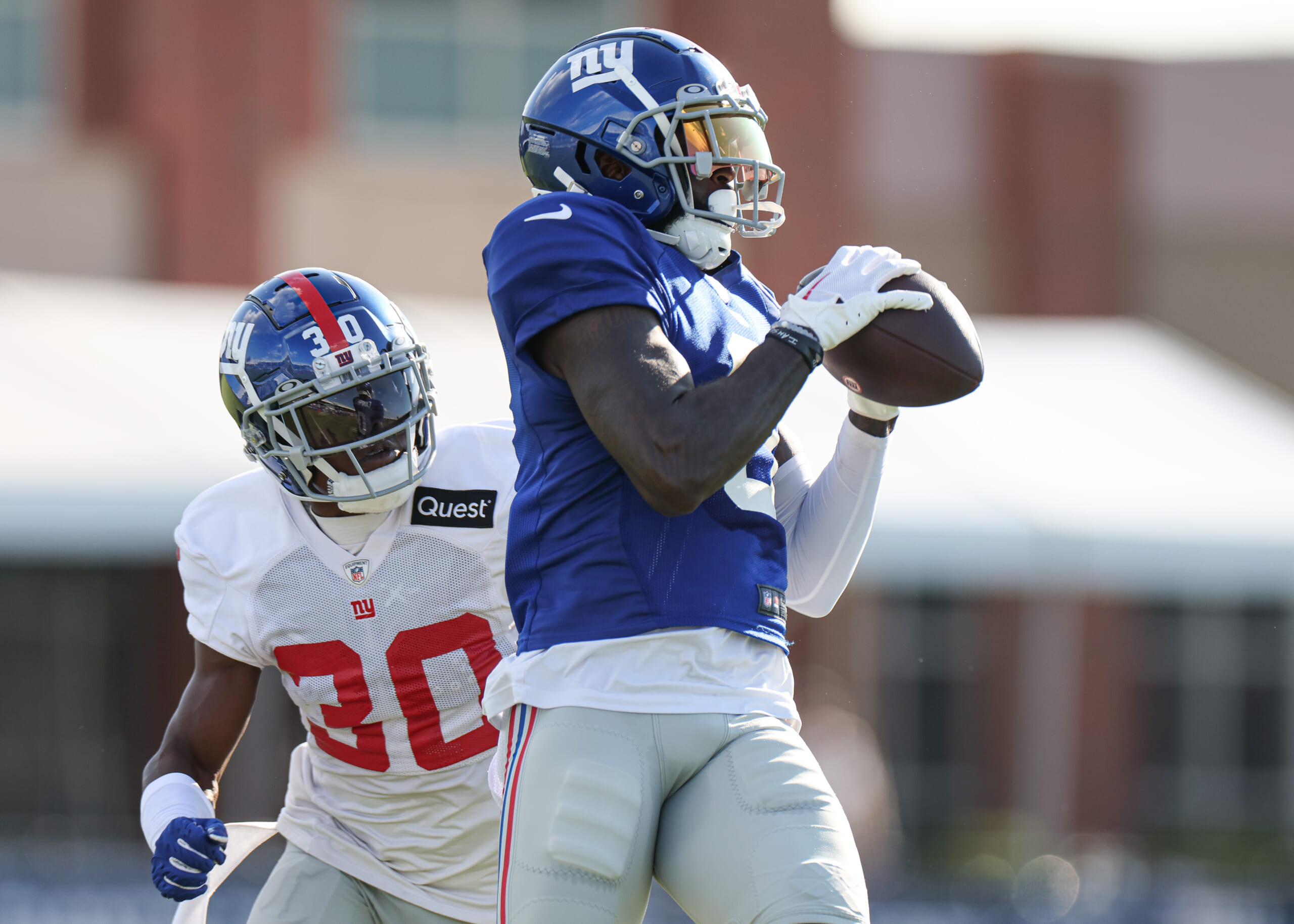 New York Giants wide receiver Parris Campbell (0) catches the ball in front of cornerback Darnay Holmes (30) during training camp at the Quest Diagnostics Training Facility