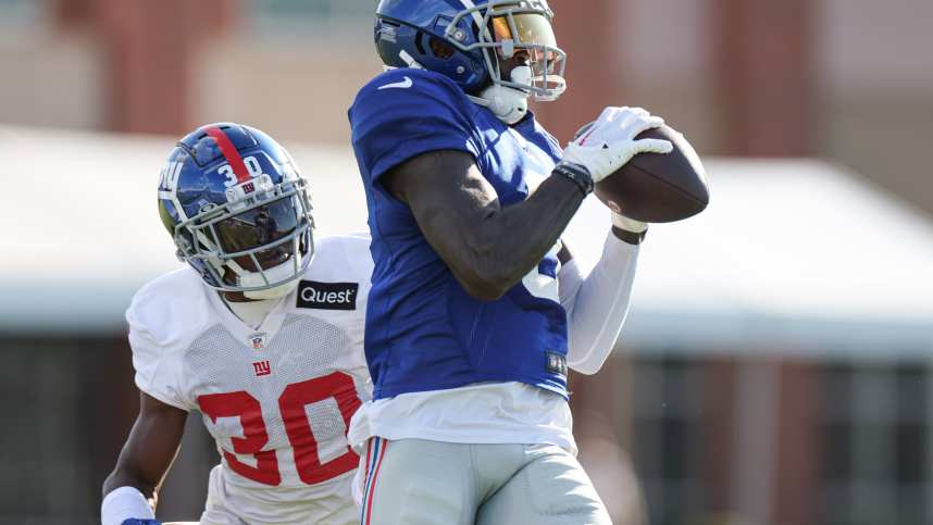 New York Giants wide receiver Parris Campbell (0) catches the ball in front of cornerback Darnay Holmes (30) during training camp at the Quest Diagnostics Training Facility