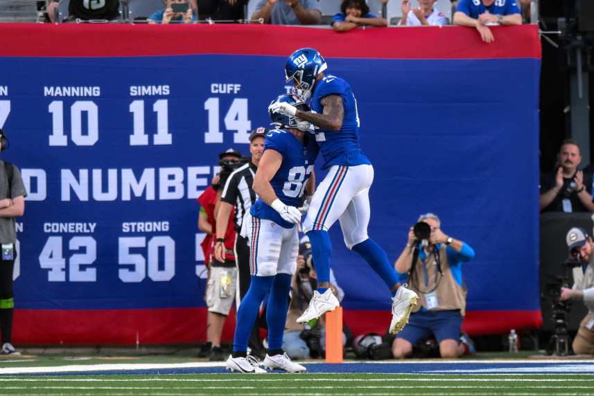 New York Giants tight end Daniel Bellinger (82) celebrates with New York Giants tight end Darren Waller (12) after catching a touchdown pass against the Carolina Panthers during the first quarter at MetLife Stadium