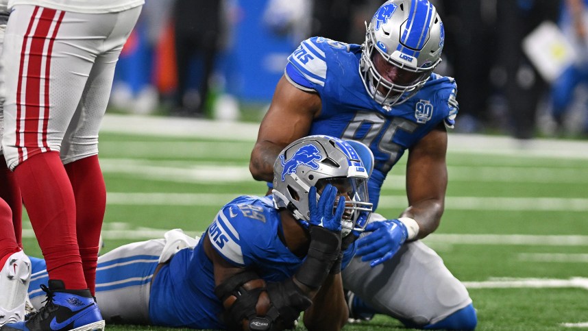 Detroit Lions linebacker Julian Okwara (99) celebrates with linebacker Romeo Okwara (95) after sacking New York Giants quarterback Tommy DeVito (5) (not pictured) in the fourth quarter at Ford Field