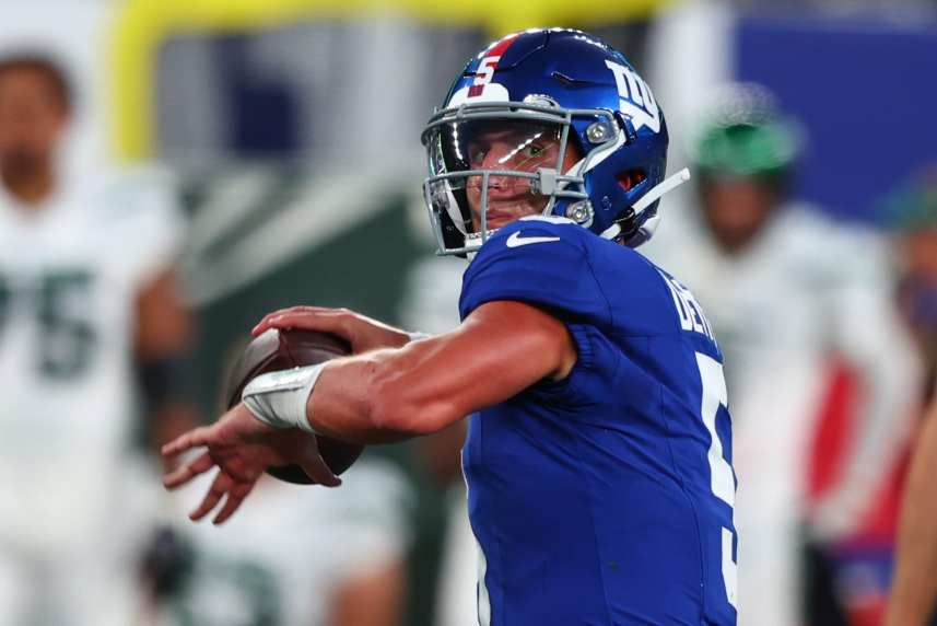 New York Giants quarterback Tommy DeVito (5) throws a pass against the New York Jets during the first half at MetLife Stadium