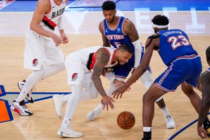 Portland Trail Blazers guard Damian Lillard (0) drives against New York Knicks center Mitchell Robinson (23) and guard Elfrid Payton (6) during the first half of an NBA basketball game, Saturday, Feb. 6, 2021, in New York
