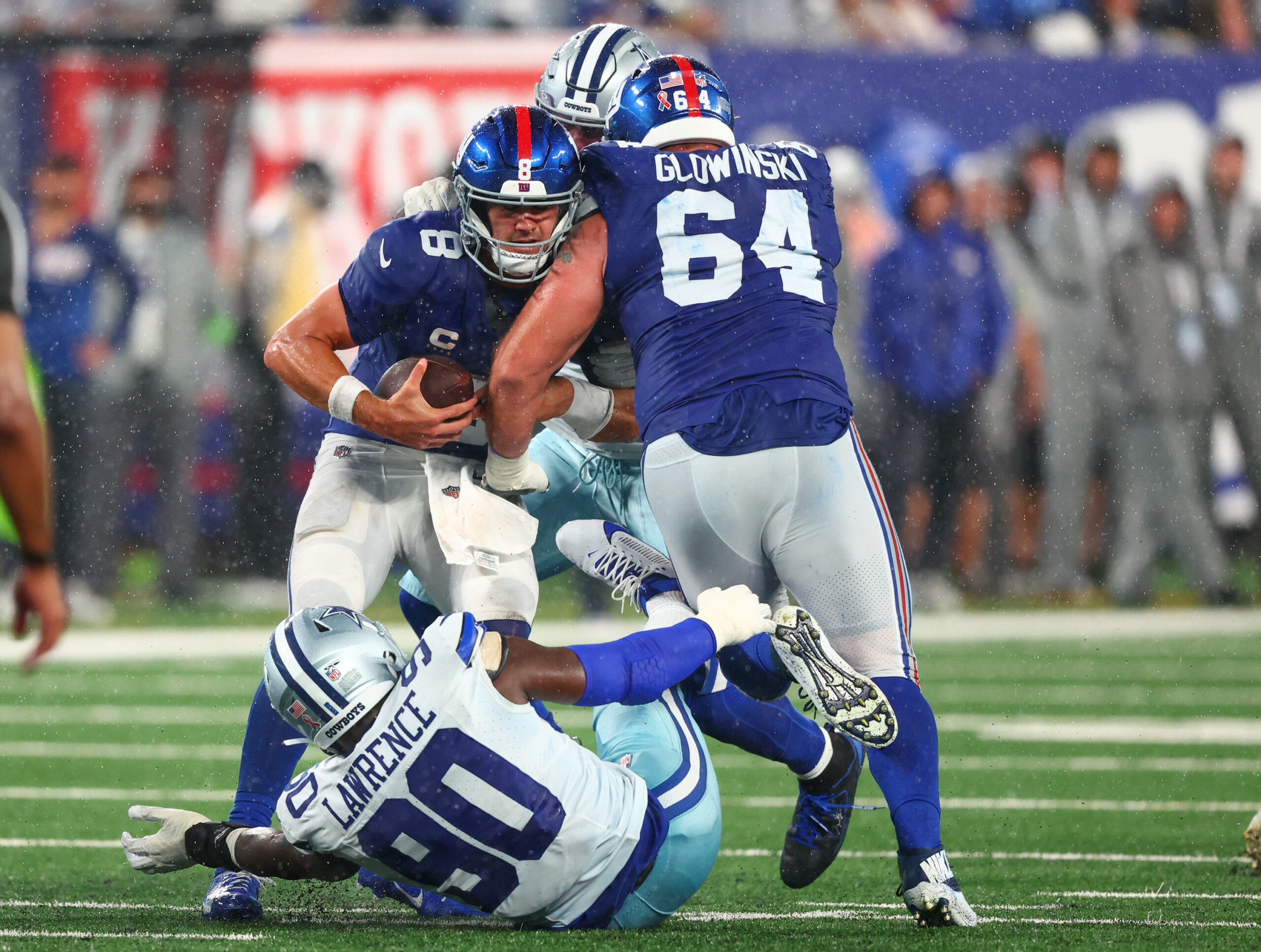 New York Giants quarterback Daniel Jones (8) is sacked by Dallas Cowboys defensive end DeMarcus Lawrence (90) during the second half at MetLife Stadium, Mark Glowinski