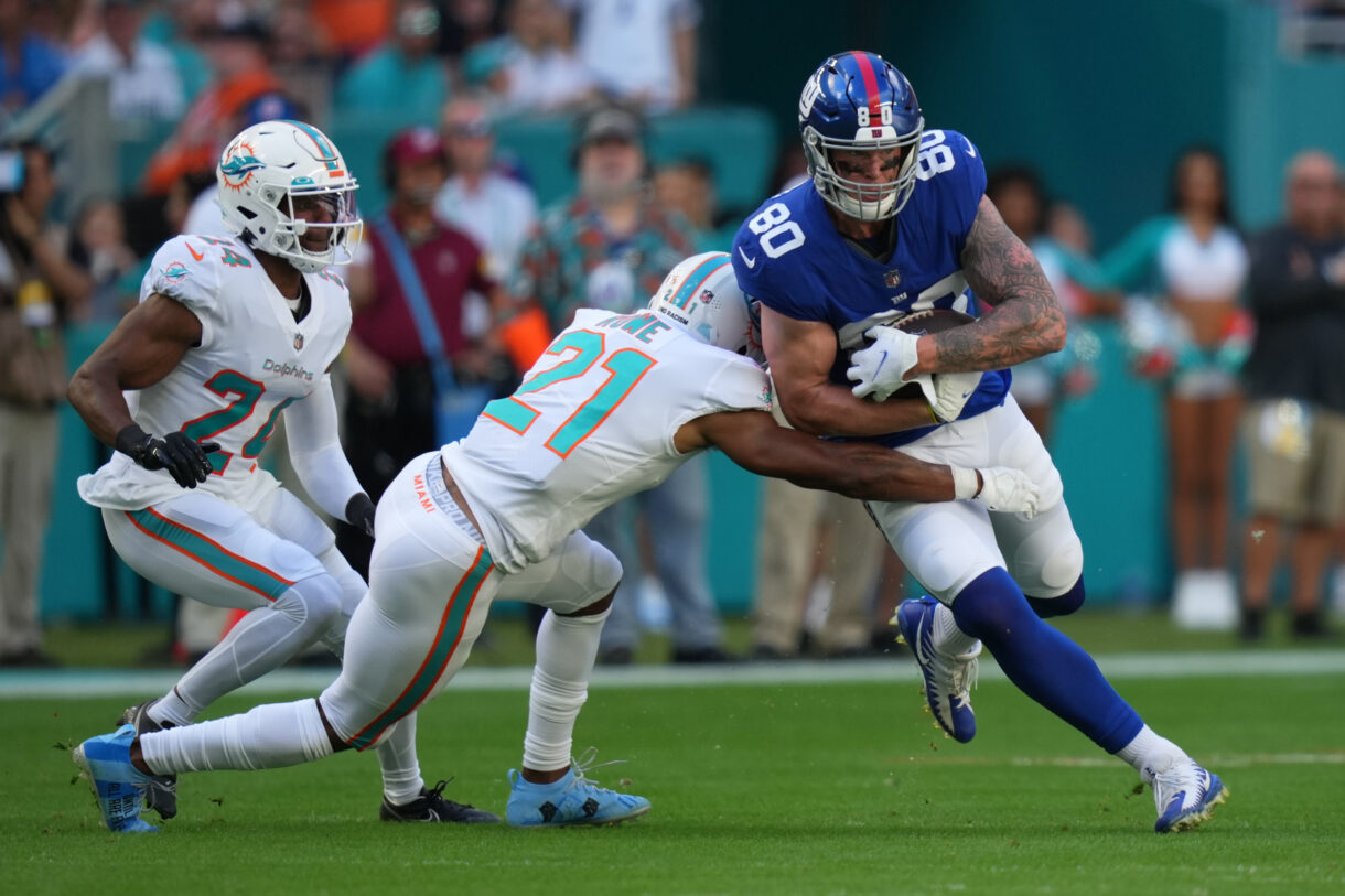 Miami Dolphins free safety Eric Rowe (21) tackles New York Giants tight end Kyle Rudolph (80) during the first half at Hard Rock Stadium