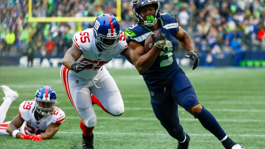 Seattle Seahawks running back Kenneth Walker III (9) escapes a tackle attempt by New York Giants linebacker Jihad Ward (55) to rush for a touchdown during the fourth quarter at Lumen Field