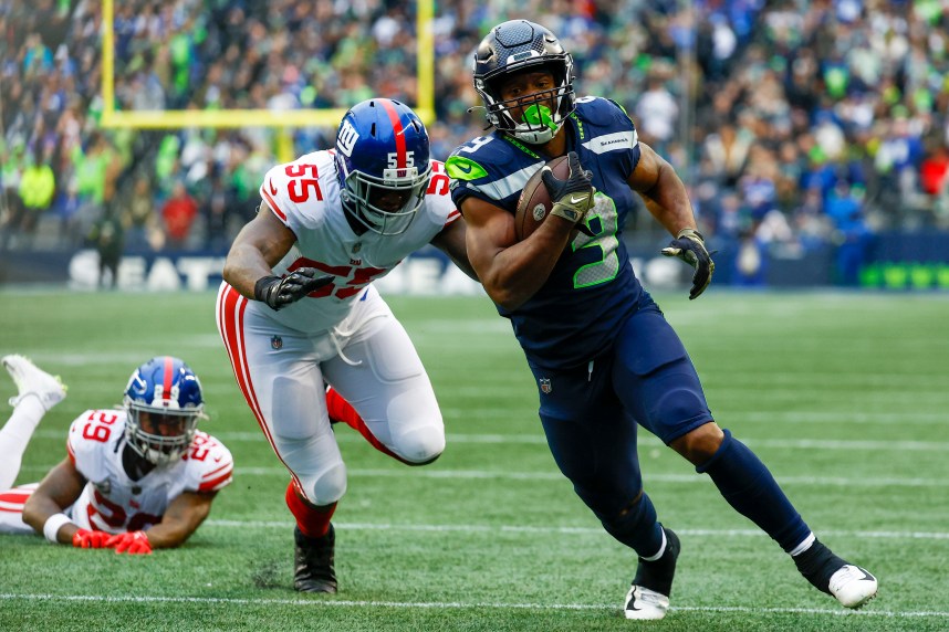 Seattle Seahawks running back Kenneth Walker III (9) escapes a tackle attempt by New York Giants linebacker Jihad Ward (55) to rush for a touchdown during the fourth quarter at Lumen Field