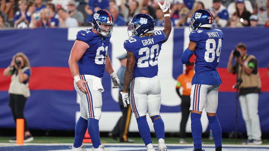 New York Giants running back Eric Gray (20) celebrates his rushing touchdown  with center John Michael Schmitz Jr. (61) and wide receiver Jalin Hyatt (84) during the first half against the Carolina Panthers at MetLife Stadium.