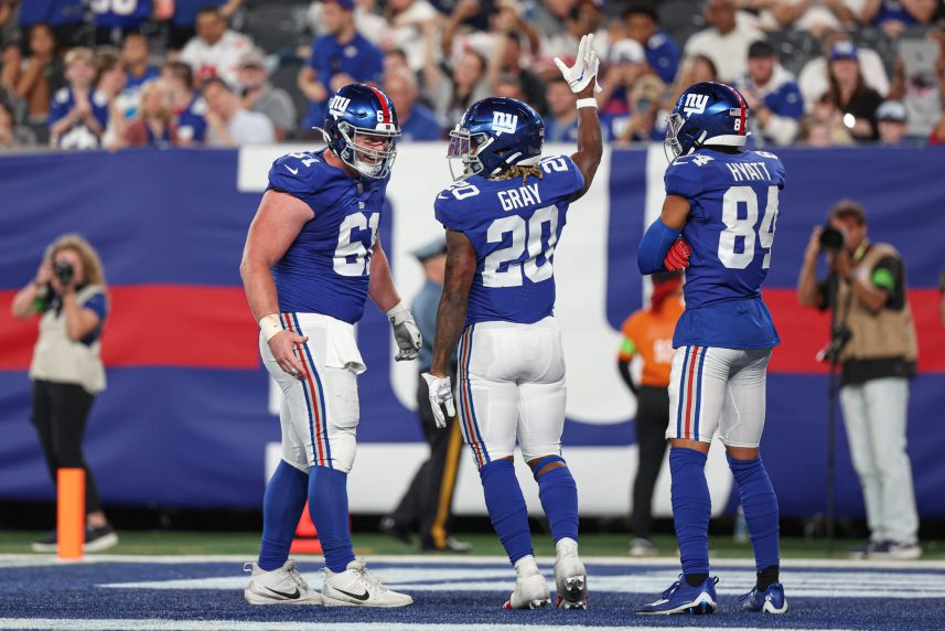 New York Giants running back Eric Gray (20) celebrates his rushing touchdown  with center John Michael Schmitz Jr. (61) and wide receiver Jalin Hyatt (84) during the first half against the Carolina Panthers at MetLife Stadium