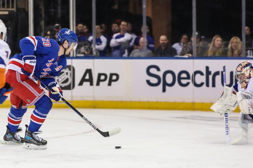 New York Rangers left wing Chris Kreider (20) attempts a shot on goal in the first period against the New York Islanders at Madison Square Garden