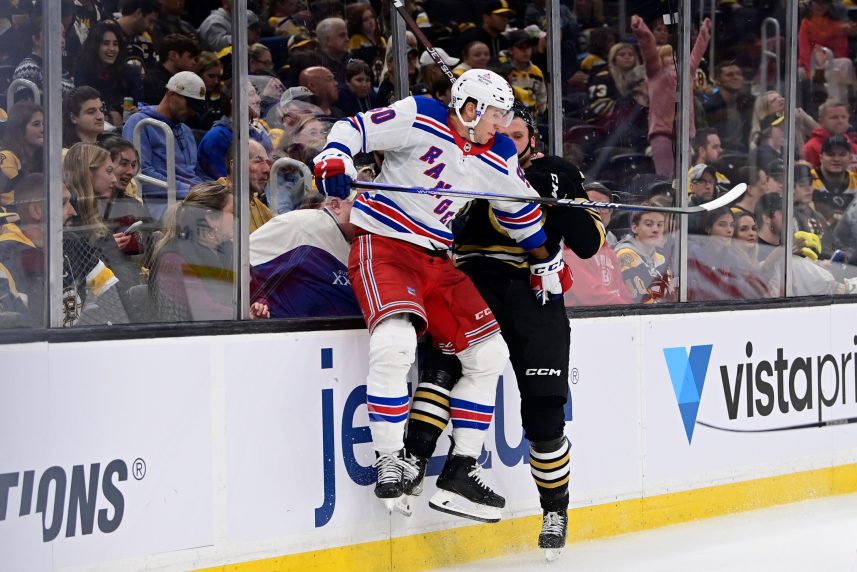 Boston Bruins defenseman Alec Regula (75) gets checked by New York Rangers left wing Will Cuylle (50) during the second period at TD Garden