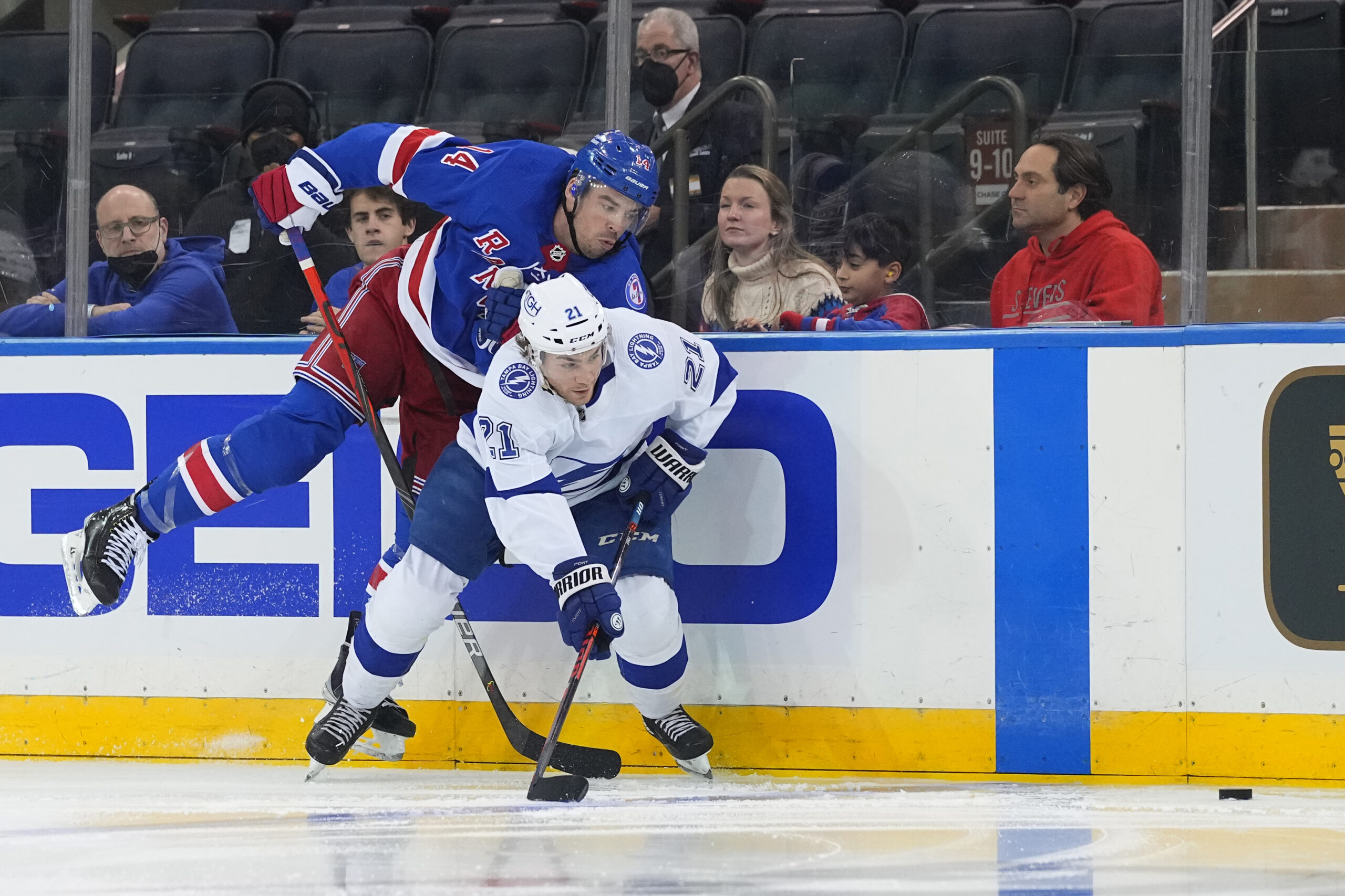 Tampa Bay Lightning center Brayden Point (21) and New York Rangers defenseman Matthew Robertson (44) chase the puck during the third period at Madison Square Garden