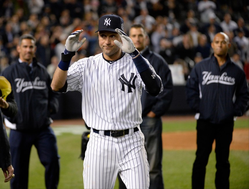 New York Yankees shortstop Derek Jeter (2) reacts with Jorge Posada, Andy Pettitte, and Mariano Rivera after defeating the Baltimore Orioles at Yankee Stadium